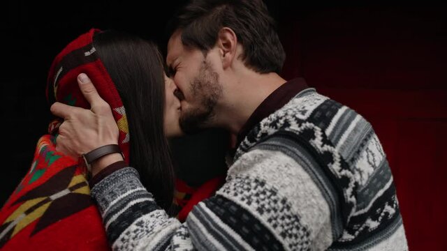 A Couple Kissing  Tight And Cuddling In Front Of An Old Rustic House