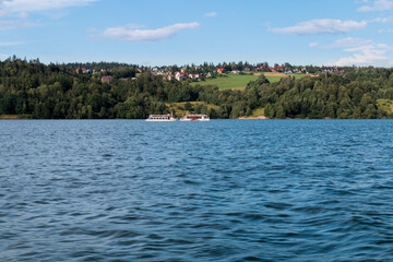 two tourist ships passing through the lake