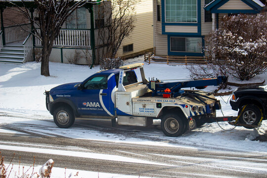 Calgary, Alberta, Canada. March 26, 2021. A close up to An Alberta Motor Association (AMA) Tow truck Roadside Assistance Towing truck during winter.