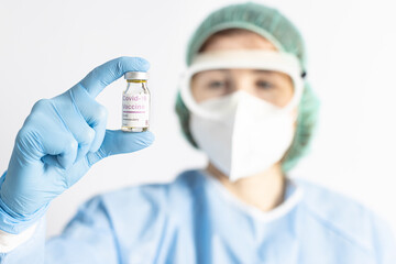 Nurse showing a bottle of covid-19 vaccine. Pandemic concept. Selective focus.