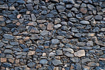 Authentic old (19th century) hand laid stone wall made of black basalt stones and boulders. A dry wall - no cement nor other compounds used to stabilise the structure.