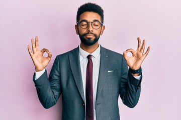 Handsome hispanic business man with beard wearing business suit and tie relax and smiling with eyes closed doing meditation gesture with fingers. yoga concept.