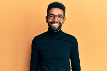 Obraz premium Handsome hispanic man with beard wearing turtleneck sweater with a happy and cool smile on face. lucky person.