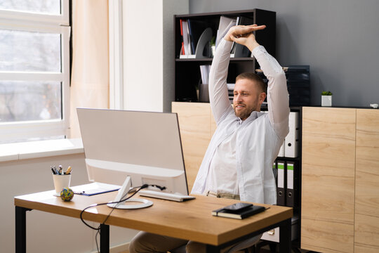 Stretch Exercise At Office Desk. Businessman