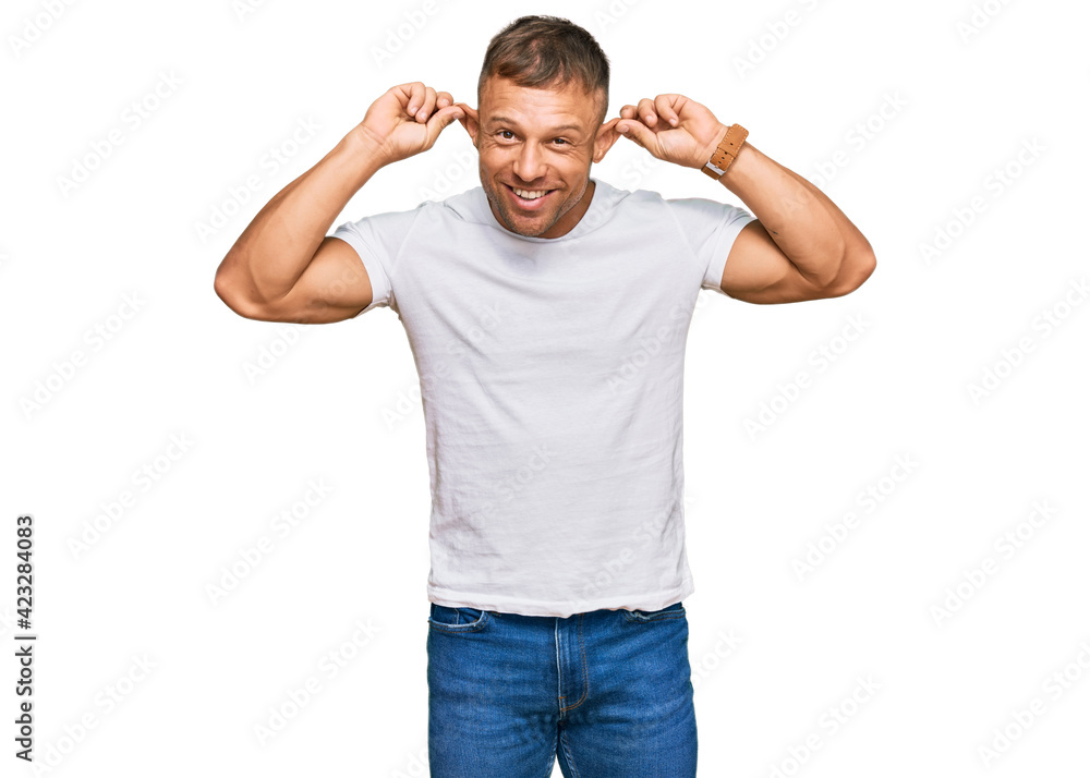 Sticker handsome muscle man wearing casual white tshirt smiling pulling ears with fingers, funny gesture. au