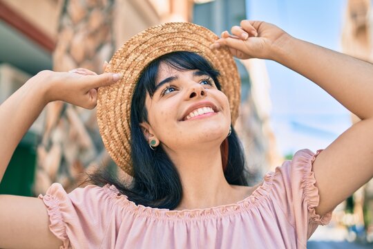 Young hispanic tourist girl wearing summer style walking at the city.