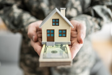 SCRA Program. Military Army Man Holding New House