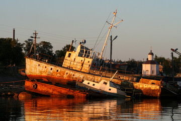Fototapeta premium Old ship lies on the bank on the Solovki islands during sunset