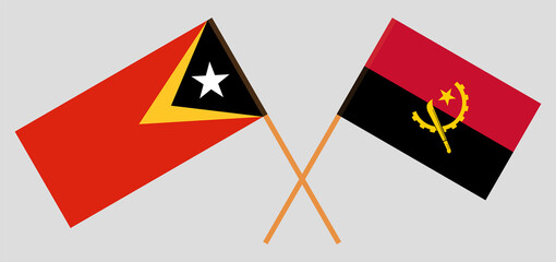 Crossed flags of East Timor and Angola. Official colors. Correct proportion