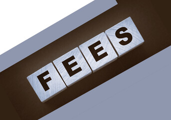 Wooden blocks with the word Fees . Taxes and fees business concept
