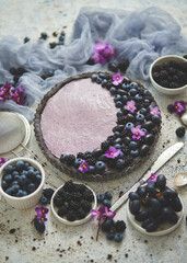 Obraz na płótnie Canvas Homemade blackberry tart. Sweet pie with blackberrym blueberry and grapes on stone table