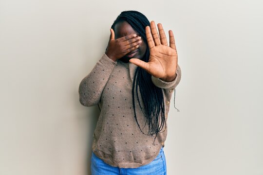 Young Black Woman With Braids Wearing Casual Clothes And Glasses Covering Eyes With Hands And Doing Stop Gesture With Sad And Fear Expression. Embarrassed And Negative Concept.