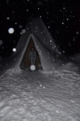 Fototapeta na wymiar Lost in the snow wigvam. Fabulous winter adventure.