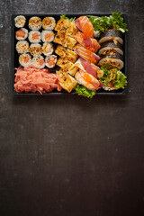 Sushi take-away plastic tray with diffent kinds of rolls and copy space. Take-away food concept.