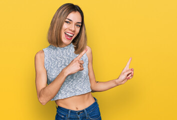 Young blonde girl wearing casual style with sleeveless shirt smiling and looking at the camera...