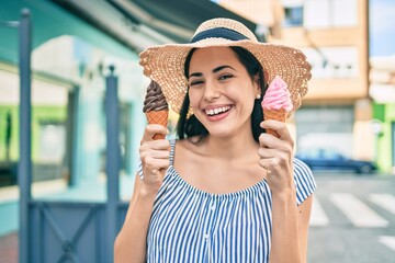 Young latin tourist girl on vacation smiling happy eating ice cream at the city.