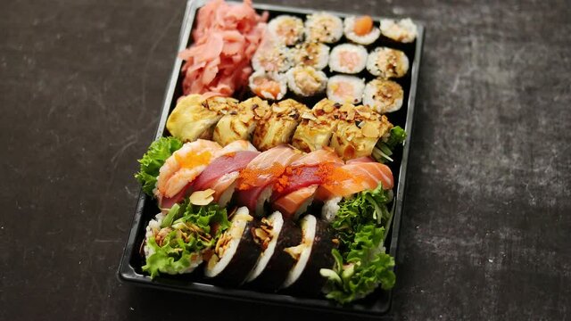 Various Sushi take-away trays with chopsticks and copy space. Take-away food concept.