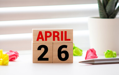 April 26th.April 26 white wooden calendar on vintage wood abstract background. Spring day....