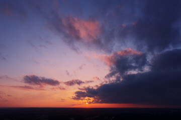 Aerial view of an orange or pink sky, a beautiful sunset, the clouds are highlighted with bright light.Evening time.