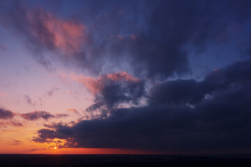 Aerial view of an orange or pink sky, a beautiful sunset, the clouds are highlighted with bright light.Evening time.