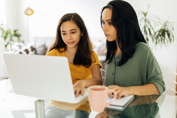 Mother helping daughter with her homework