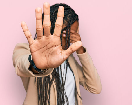 African american woman wearing business jacket covering eyes with hands and doing stop gesture with sad and fear expression. embarrassed and negative concept.