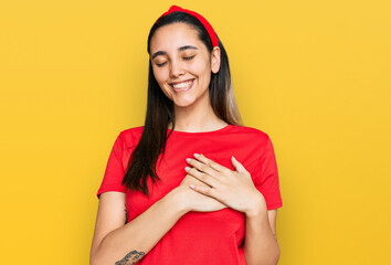Young hispanic woman wearing casual clothes smiling with hands on chest with closed eyes and grateful gesture on face. health concept.