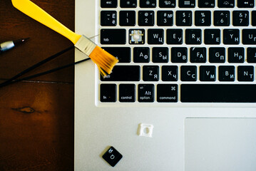 screwdriver and spare parts from a laptop. Keyboard, brush, keys. Laptop repair