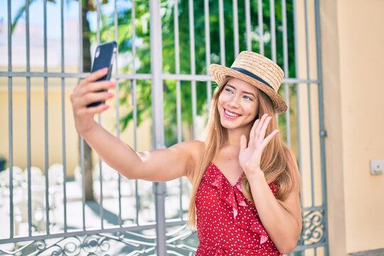 Young caucasian tourist girl smiling happy doing video call using smartphone at the city.