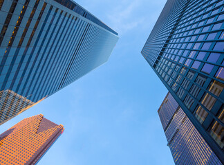 Tall office buildings reach up to the blue sky.