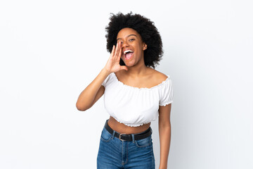 Fototapeta na wymiar Young African American woman isolated on white background shouting with mouth wide open