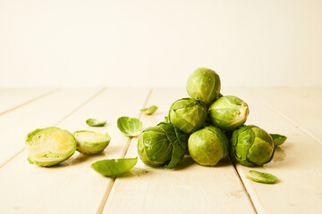 Bunch of fresh raw Brussel sprouts on a white wood table