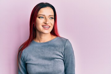 Young caucasian woman wearing casual clothes looking to side, relax profile pose with natural face and confident smile.