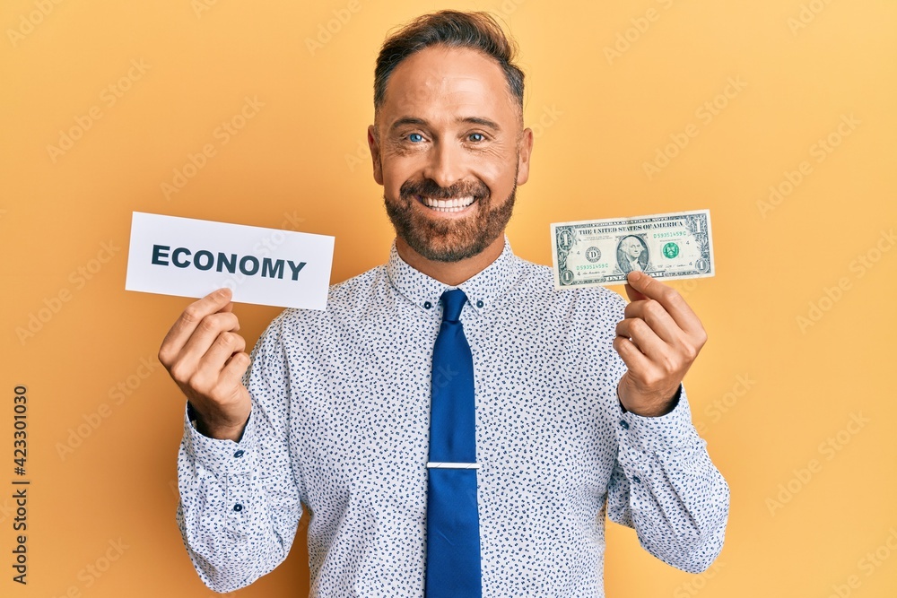 Sticker handsome middle age man holding economy message and holding 1 dollar smiling with a happy and cool s