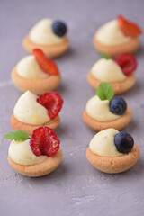 Sablés - French butter biscuits with vanilla cream and fresh berries in petit four