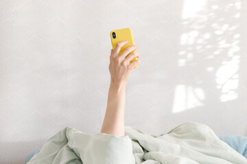 good morning, sunny day woman checking messages, phone in hand, yellow phone, communication, start...