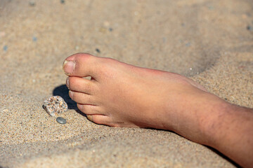 Close up of male feet in sand