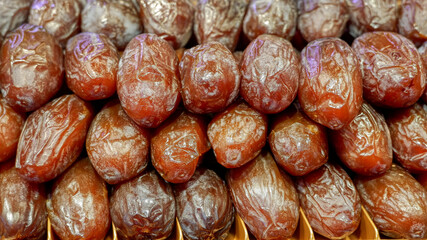 Fresh dates for sale in the Valencia market. They are laid neatly in even rows