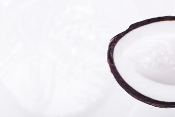 Half of a coconut with water flowing out