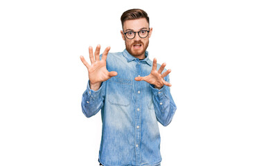 Young redhead man wearing casual denim shirt afraid and terrified with fear expression stop gesture...