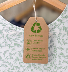 Recycled care label on t shirt, sustainable fashion wash cold, line dry, mend and repair, reuse,...