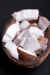 Half of a coconut with water flowing out