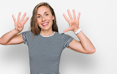 Young blonde woman wearing casual clothes showing and pointing up with fingers number nine while...