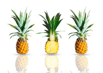 Ripe whole and cut pineapples isolated on white background. Exotic tropical fruit