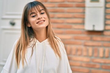 Caucasian teenager girl smiling happy standing at the city.