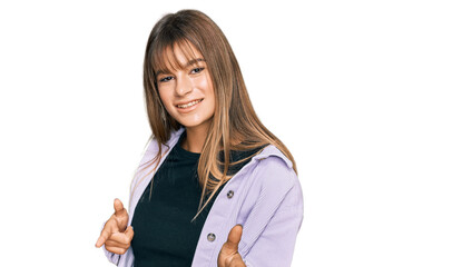 Teenager caucasian girl wearing casual clothes pointing fingers to camera with happy and funny face. good energy and vibes.