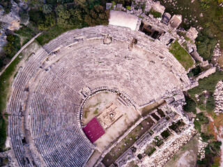 High angle drone aerial view of ancient greek rock cut lykian empire amphitheatre and tombs in Myra (Demre, Turkey)