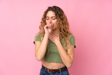 Young blonde woman with curly hair isolated on pink background is suffering with cough and feeling...