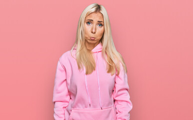 Young blonde woman wearing casual sweatshirt depressed and worry for distress, crying angry and afraid. sad expression.