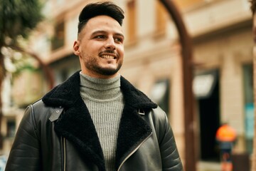 Young arab man smiling happy standing at the city.